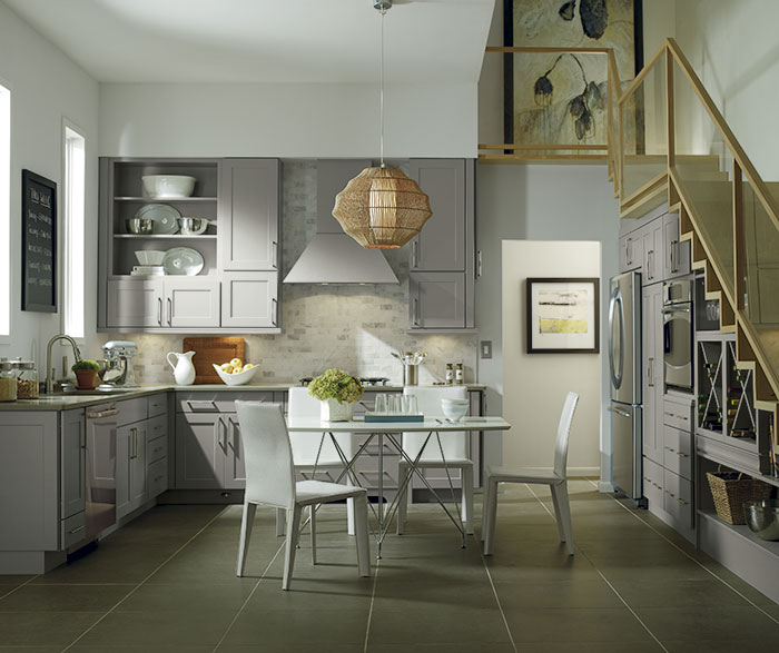grey cabinets in casual kitchen featuring under-stairs storage